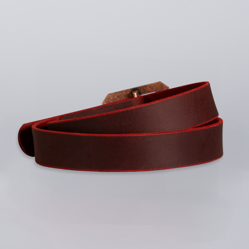 The Lainey by Hanks Belts is a coiled dark brown belt crafted from full grain crazy horse leather with bold red edges, shown against a plain light background.