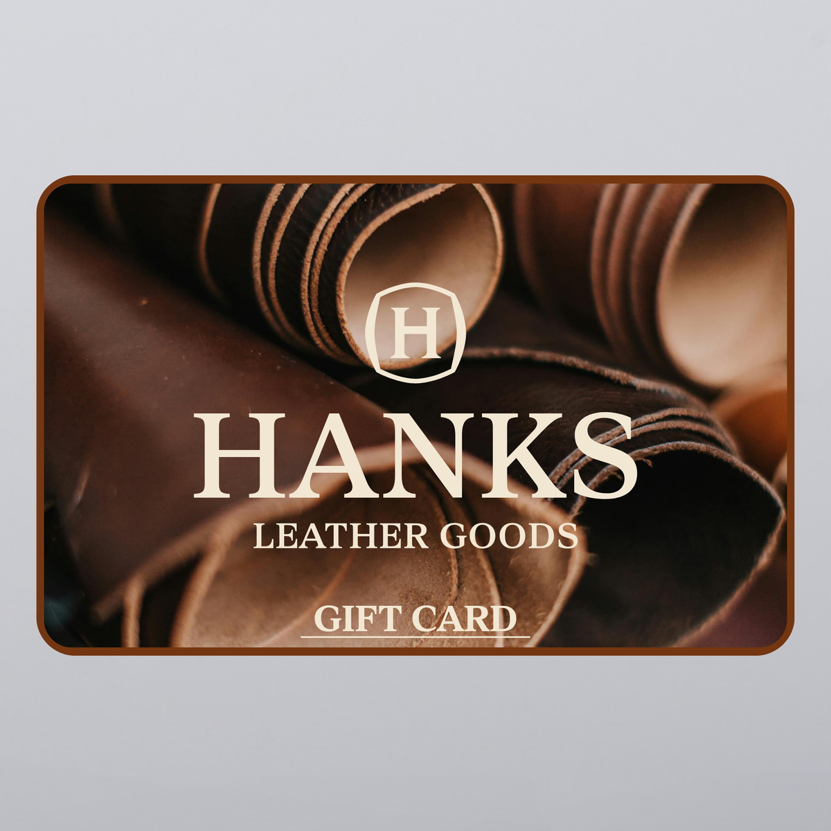 The Hanks Gift Card by Hanks Belts features a close-up of rolled brown leather and the brand logo—making it an ideal last-minute gift or perfect choice for any leather enthusiast.