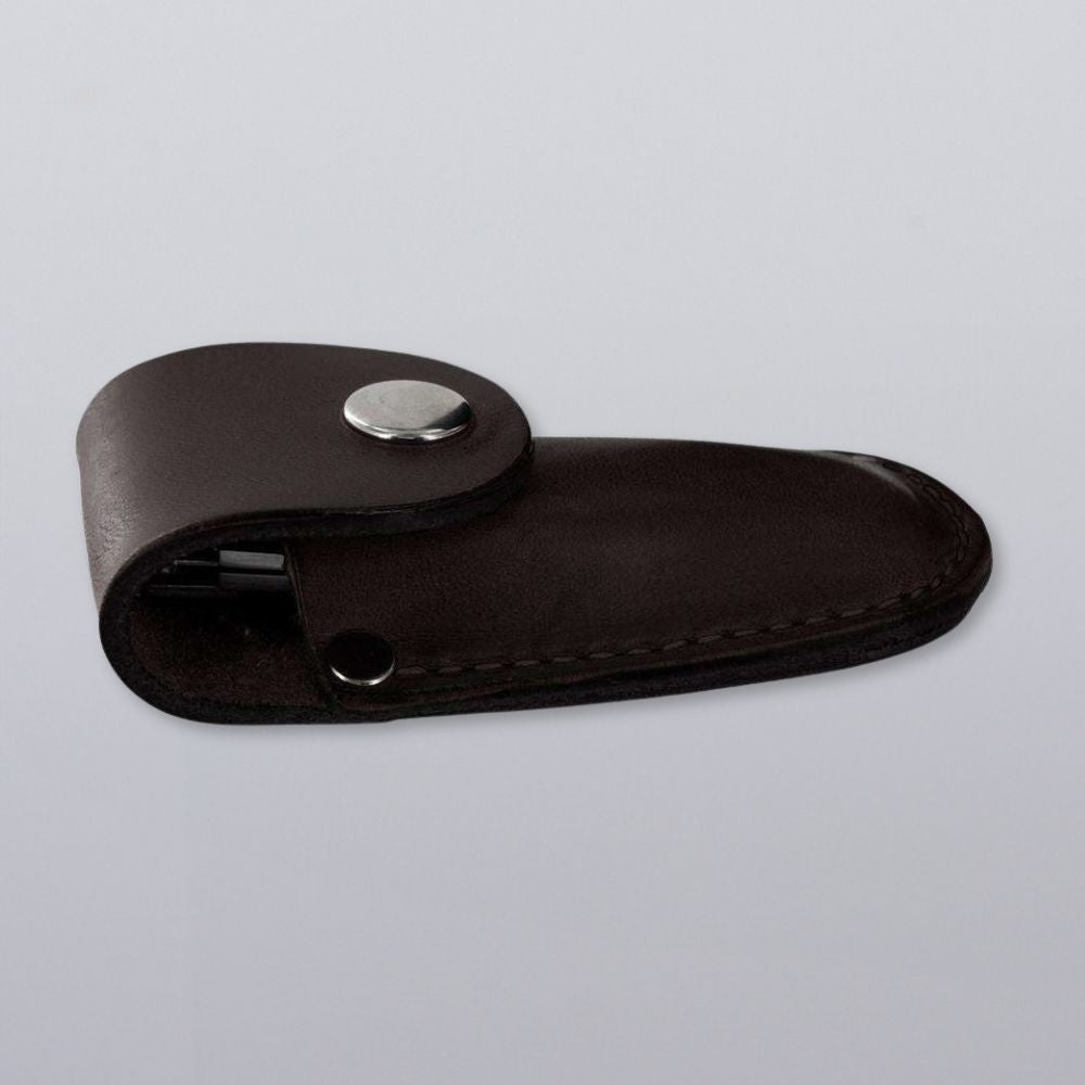 The Hanks Belts Canyon Utility Sheath and Mag Case is a closed dark brown bridle leather sheath with a snap-button flap, designed for a small folding knife, shown on a plain light gray surface.