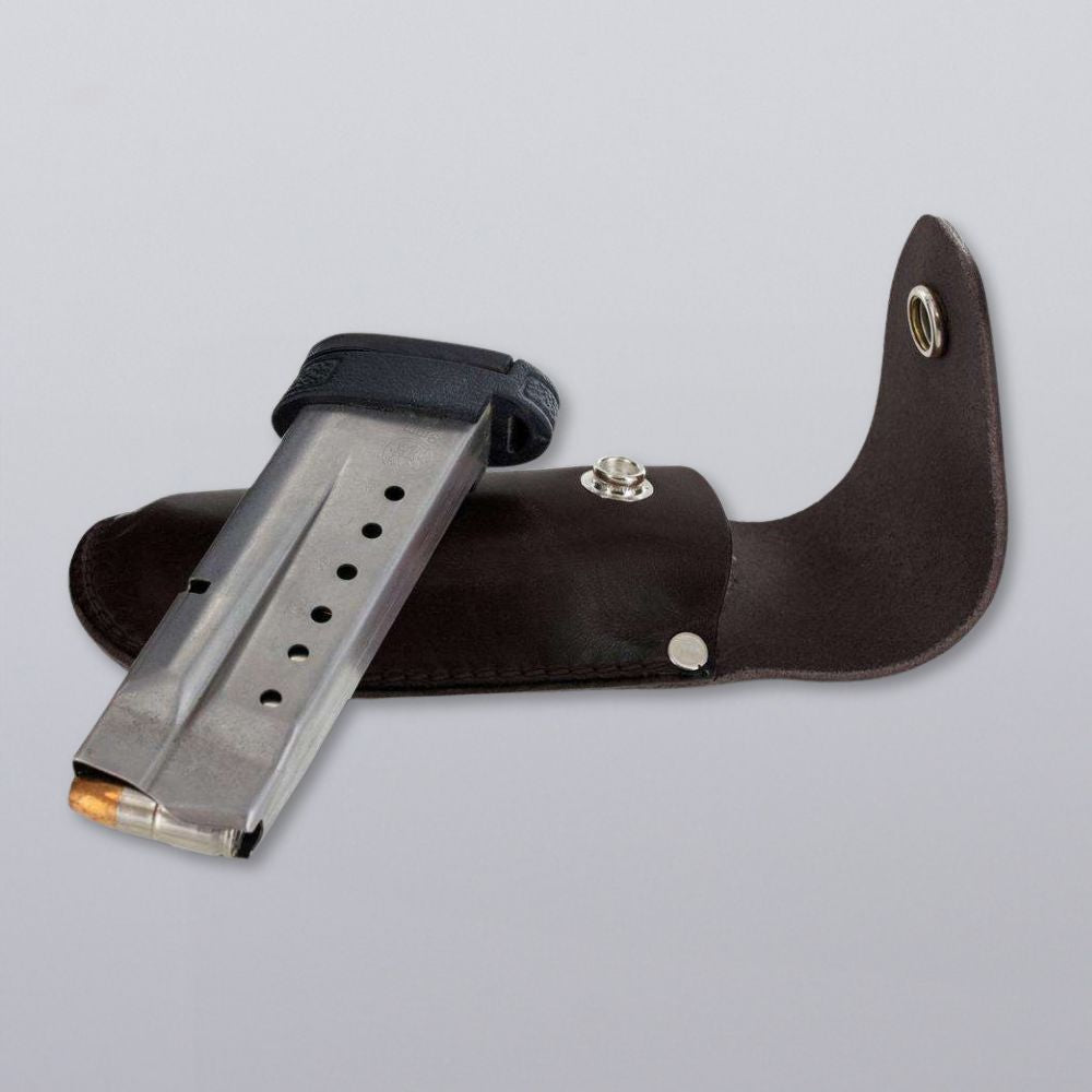 A Hanks Belts Canyon Utility Sheath and Mag Case, with a metal pistol magazine partially inserted, is displayed on a light gray background.