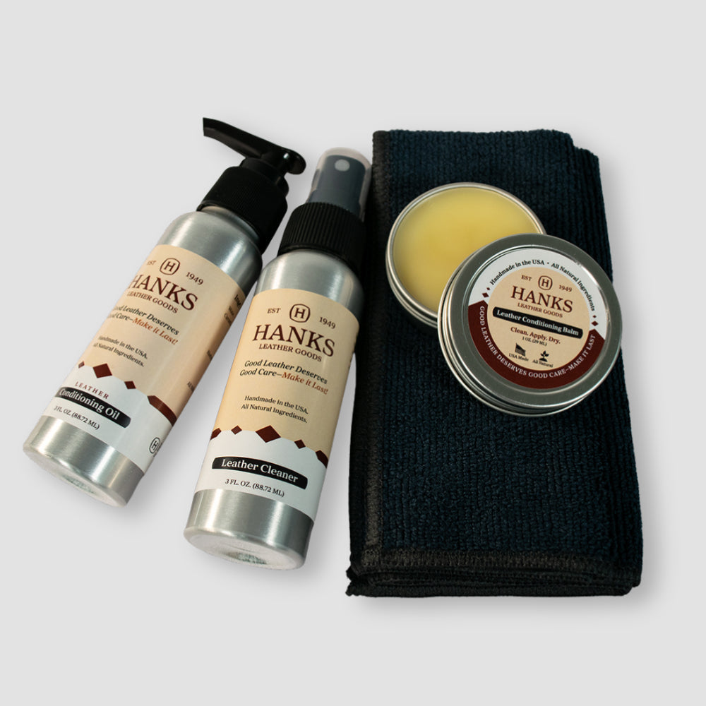 Hanks Belts Leather Preserve Kit includes two spray bottles of leather cleaner, a tin of balm, and a folded black cloth, all displayed on a light gray background.
