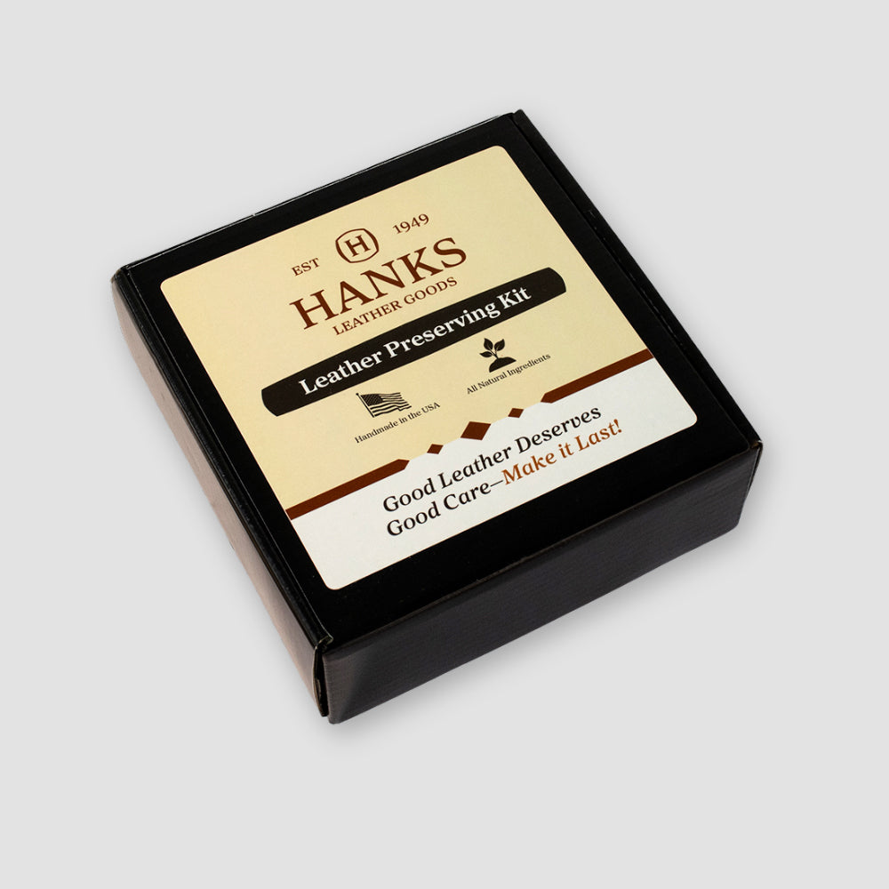 A black box labeled “Leather Preserve Kit” by Hanks Belts, with the Hanks Belts logo, icons of a flag, leaf, and cow. Text reads: “Good leather deserves good care – make it last!” Includes premium leather cleaner and conditioner.