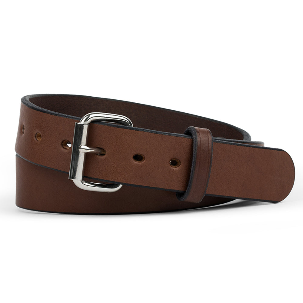 The Hanks Belts Gunner in brown is coiled on a white background, crafted from full-grain steer hide and finished with a silver buckle.
