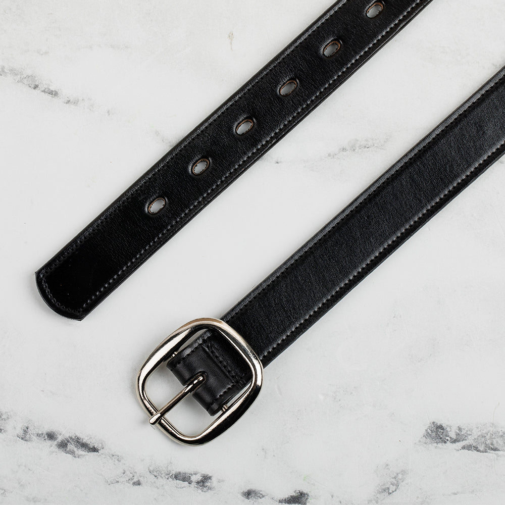 The Eloise by Hanks Belts is a women's premium black vegetable-tanned leather belt with a center bar buckle, classic design, and multiple adjustment holes, shown laid flat on a light marble surface.