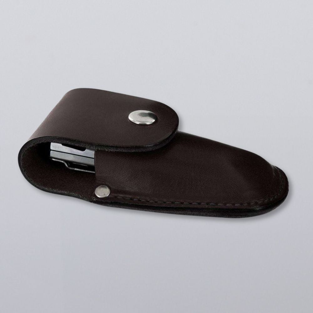 The Canyon Utility Sheath and Mag Case by Hanks Belts is a dark brown bridle leather pouch with a silver snap closure, designed to protect small tools or objects, shown on a plain light gray background.
