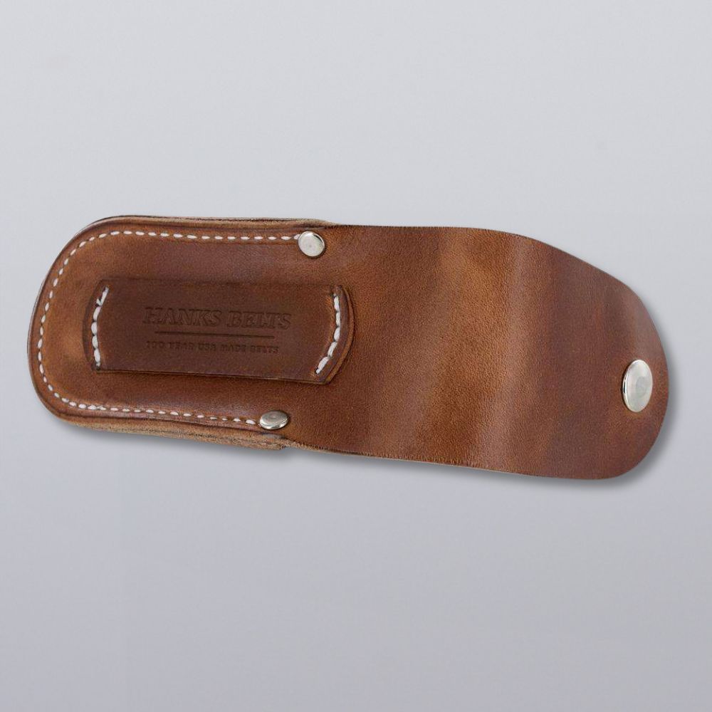 The Hanks Belts Canyon Utility Sheath and Mag Case is a handcrafted brown bridle leather sheath with white stitching, metal rivets, and embossed branding. Shown on a plain light gray background.