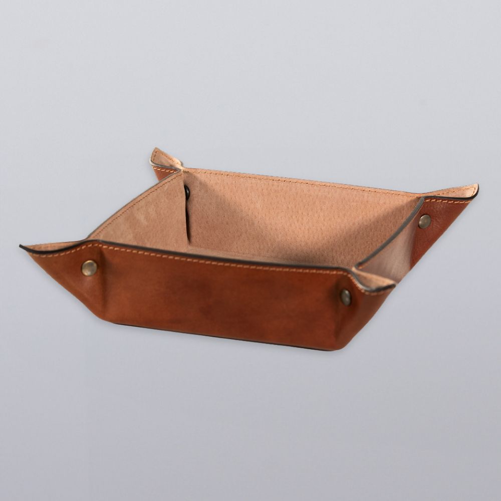 The Hanks Belts Italian Large Valet Tray, featuring raised edges and snap buttons at each corner, offers a stylish way to organize your essentials on any surface.