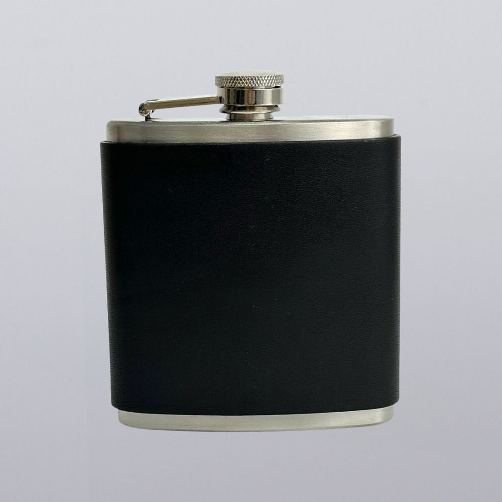The Hanks Belts Leather Covered Flask features stainless steel construction wrapped in black leather and a screw-on cap, shown against a plain light gray background.