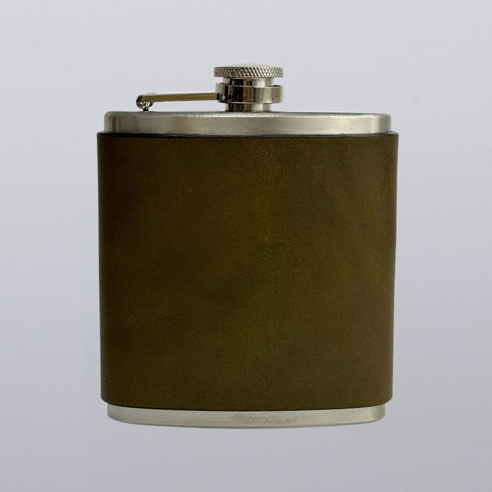 The Hanks Belts Leather Covered Flask features olive green leather wrapping, a stainless steel body, and a screw-on cap with a metal arm, shown against a plain light gray background.