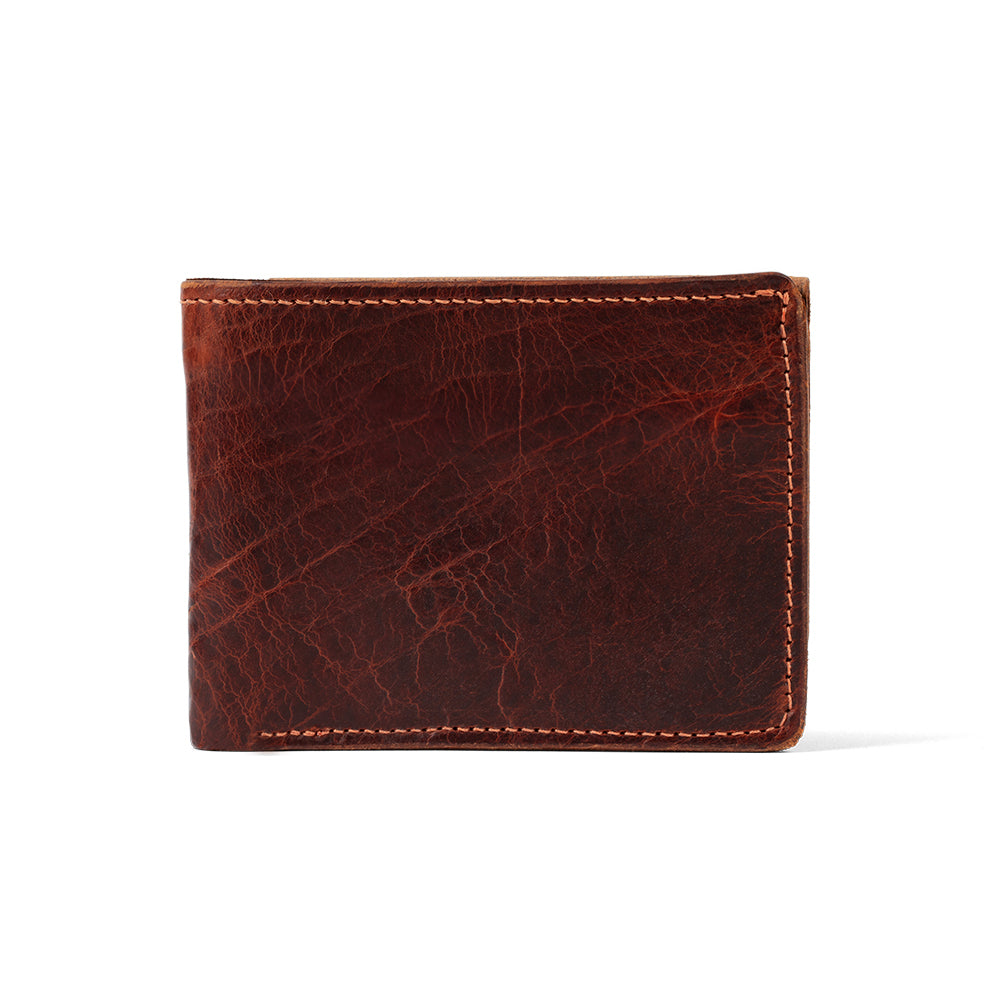 The Hanks Belts Powell Bison Bifold with ID Window is a brown leather wallet featuring visible texture, neat stitching, and ample card storage. Shown closed on a white background, it’s a practical and stylish gift choice.