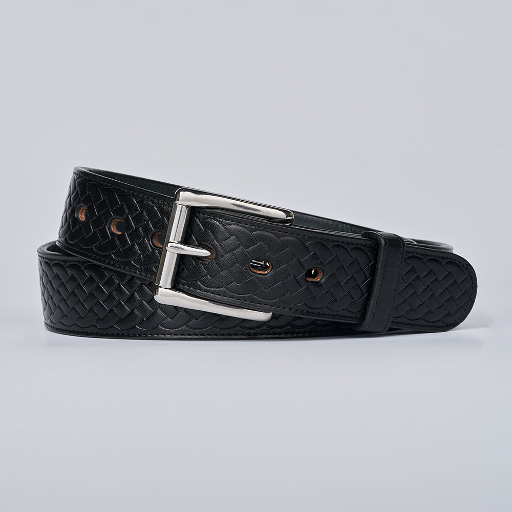 The Classic Basket Weave by Hanks Belts—a black basket weave leather belt with a silver buckle—lies coiled on a plain light gray background.
