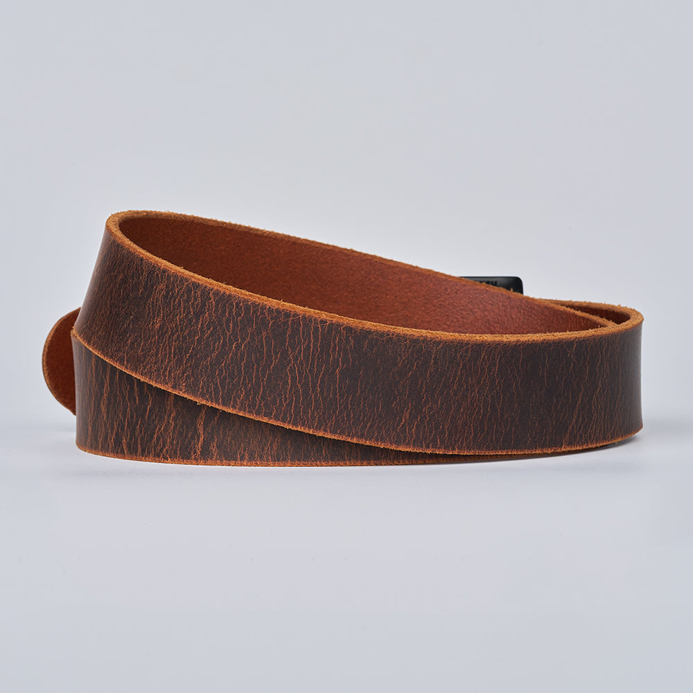 The Crazy Horse belt by Hanks Belts, featuring coiled brown retro leather with a natural distressed texture, is displayed on a plain light gray background.