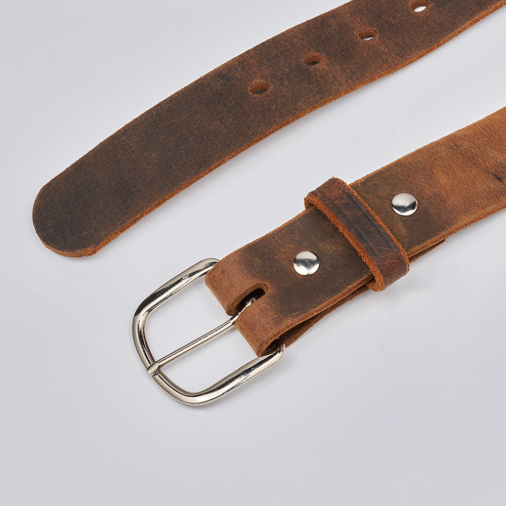 The Crazy Horse by Hanks Belts is a retro Water Buffalo leather belt with a silver buckle, metal rivets, and multiple adjustment holes. Made in the USA, it displays a rustic, worn look and is shown flat on a light gray background.