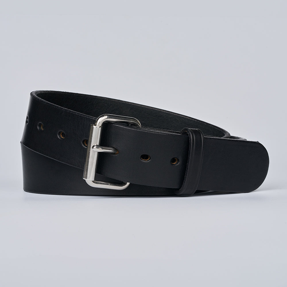 The Enforcer by Hanks Belts, a black leather gun belt with a silver buckle and multiple adjustment holes, is coiled on a light gray background. Its classic design offers both style and reliable support.