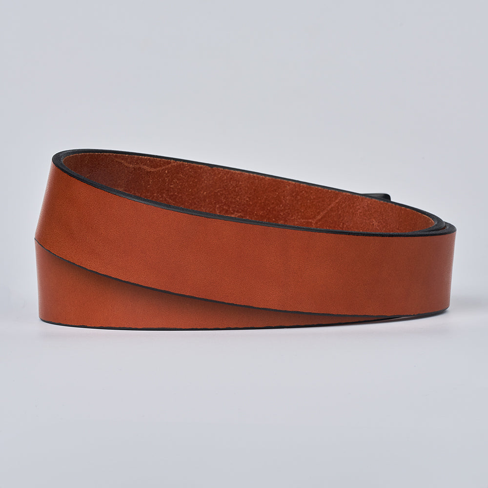 The Everyday by Hanks Belts is a coiled brown full-grain leather belt with black edges, shown on a plain light gray background. It’s simple, durable, and features no visible buckle.
