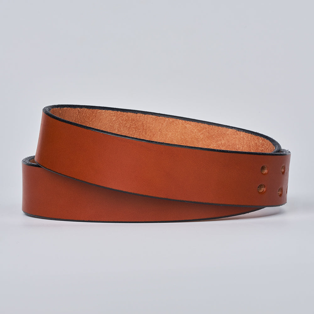 The Double Prong Everyday by Hanks Belts is a coiled, brown full-grain leather belt with a smooth finish and three holes near one end, displayed on a plain light background.
