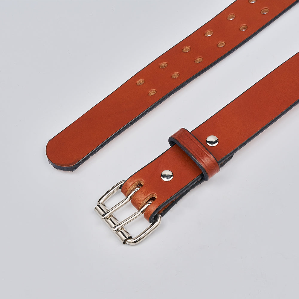 The Double Prong Everyday by Hanks Belts is a full-grain brown leather belt with a retro double prong buckle and multiple adjustment holes, shown against a plain light background.