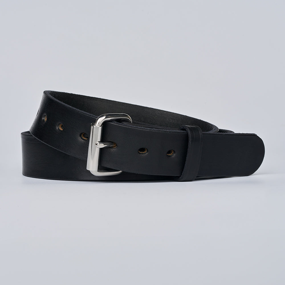 A Hanks Belts "The Gunner" black belt with a silver buckle is coiled neatly on a plain light gray background.