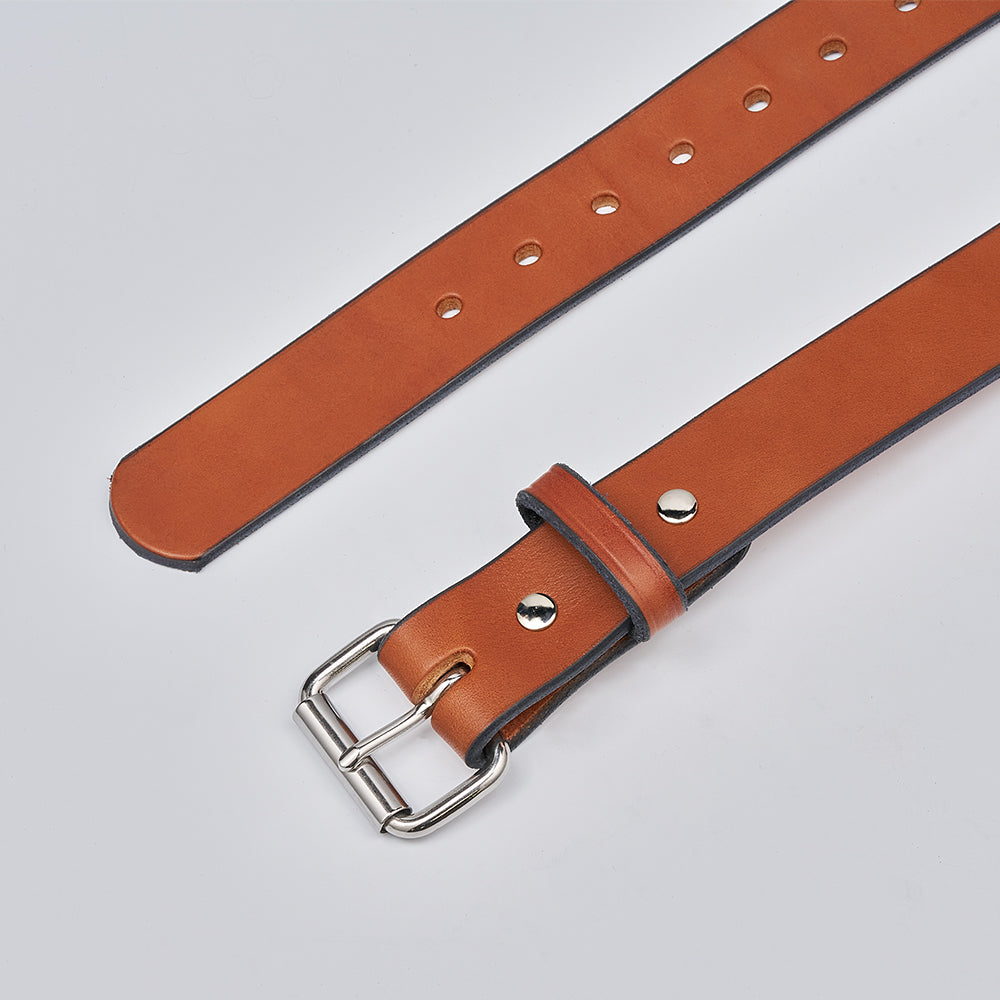 The Gunner by Hanks Belts is a brown leather CCW belt with a silver buckle and multiple adjustment holes, displayed flat on a light gray surface.