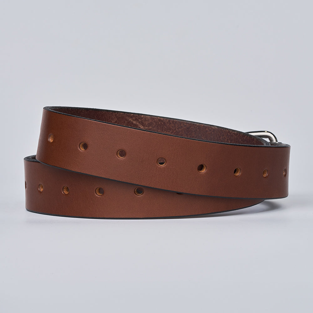 The Gunner Utility by Hanks Belts is a coiled brown leather gun belt featuring multiple evenly spaced holes, displayed on a plain light background.