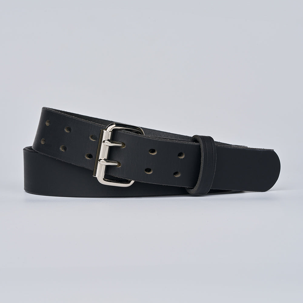 The Legend Double Prong Retro Style by Hanks Belts, crafted from black full grain leather and featuring a silver double prong roller buckle, is coiled on a light gray background with multiple adjustment holes visible.