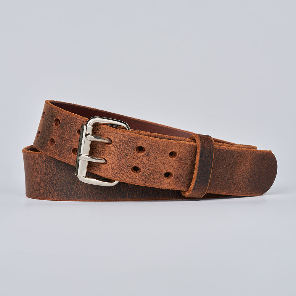 The Legend Double Prong Retro Style by Hanks Belts, crafted from full grain leather with a double prong roller buckle and multiple adjustment holes, is coiled on a plain light gray background.