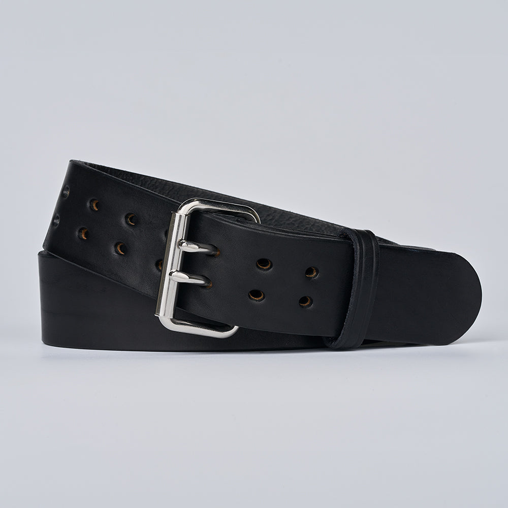 The Marshall by Hanks Belts is a black garrison-style belt featuring multiple holes and a silver buckle, coiled neatly on a plain light gray background.