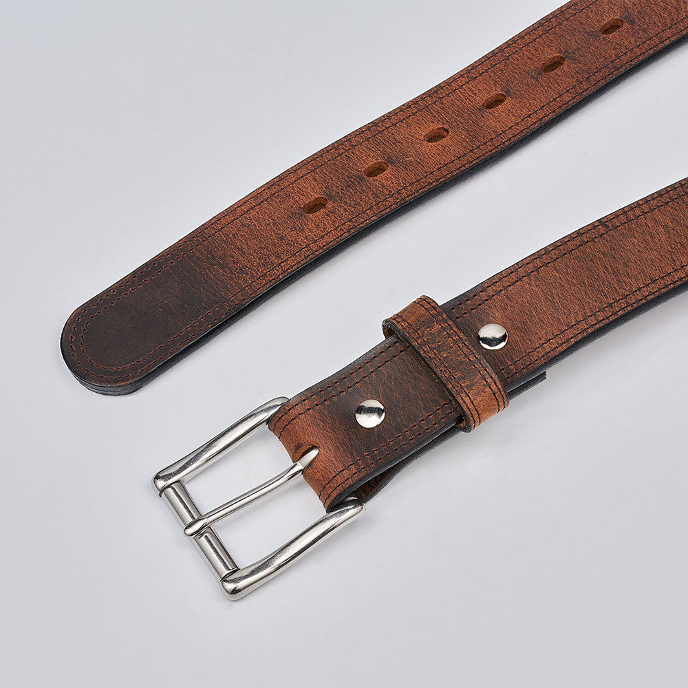 Brown leather belt with silver buckle on a light gray background