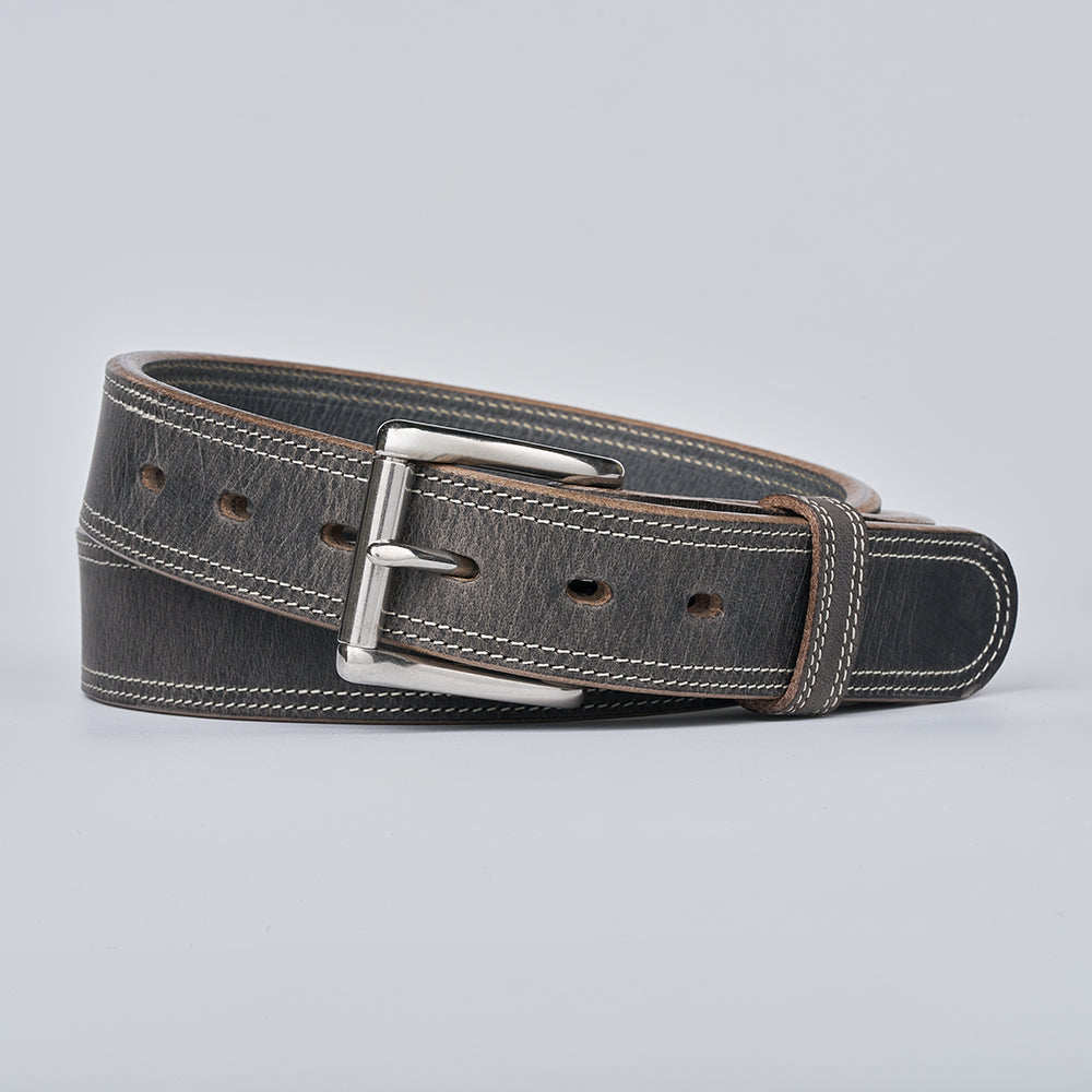Gray leather belt with a silver buckle on a light gray background
