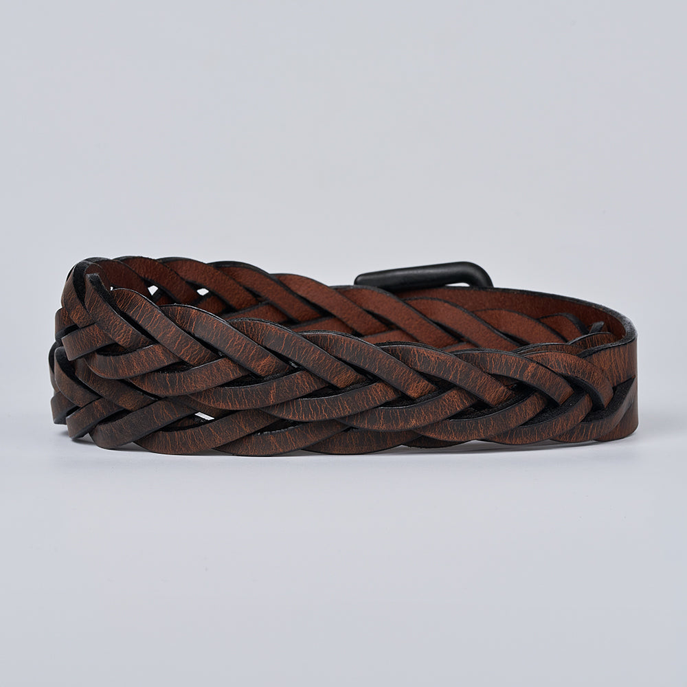 The Rockford Braided Bison by Hanks Belts—a brown braided leather belt with a black buckle, made in the USA—shown coiled on a plain light gray background.