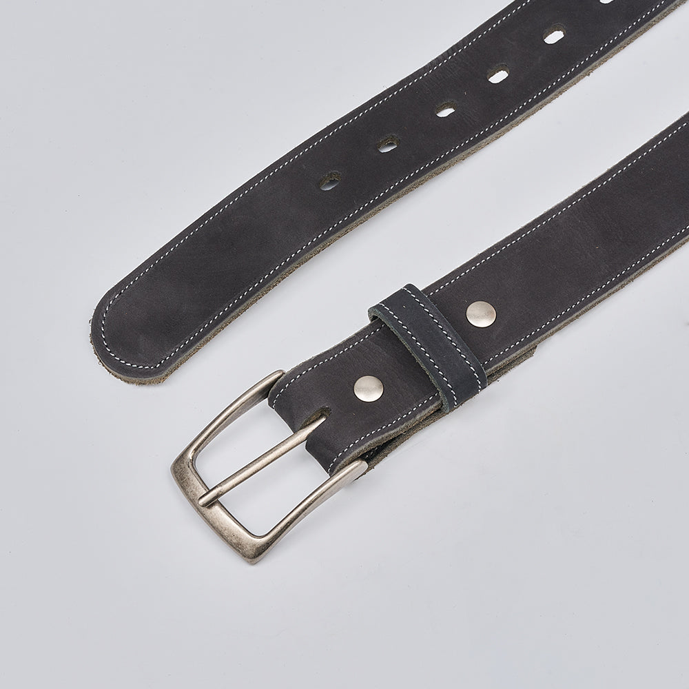 The Suede - 1.5" by Hanks Belts is a black nubuck leather belt with white stitching, a silver buckle, and multiple adjustment holes, displayed on a light gray surface.