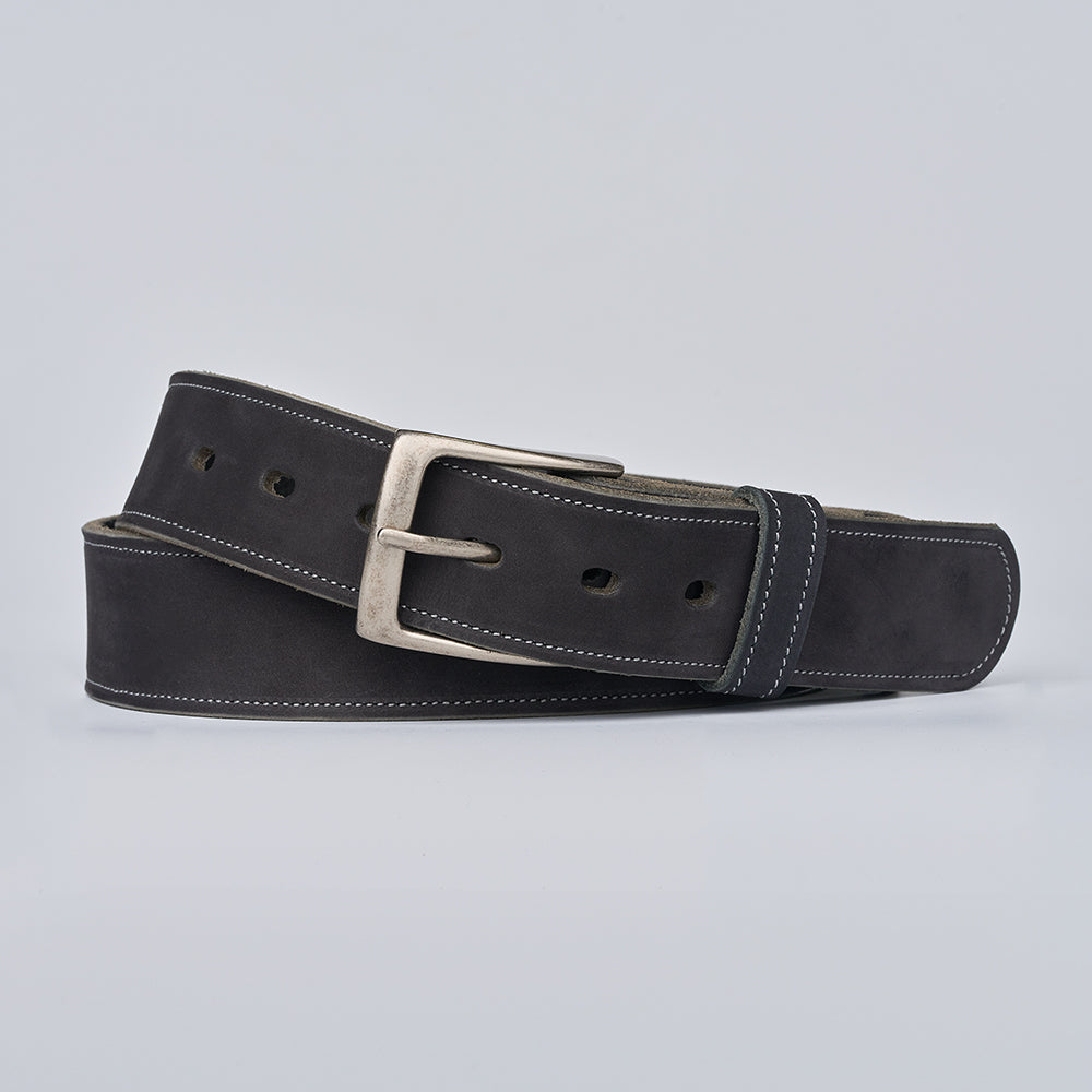 The Suede - 1.5" by Hanks Belts is a black nubuck leather belt with white stitching and a silver rectangular buckle, coiled neatly on a plain light gray background.