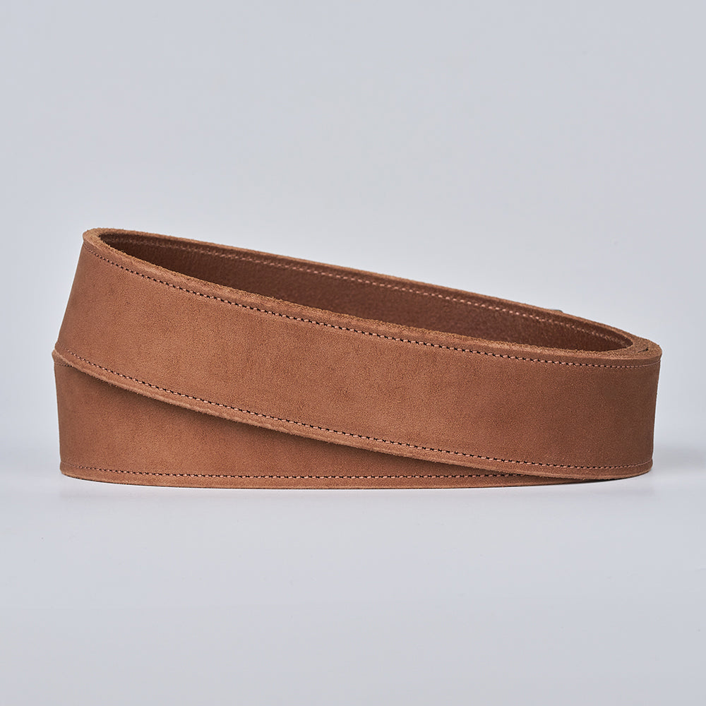 The Suede - 1.5" by Hanks Belts, a wide brown nubuck leather wrap belt, is shown coiled on a plain light gray background.