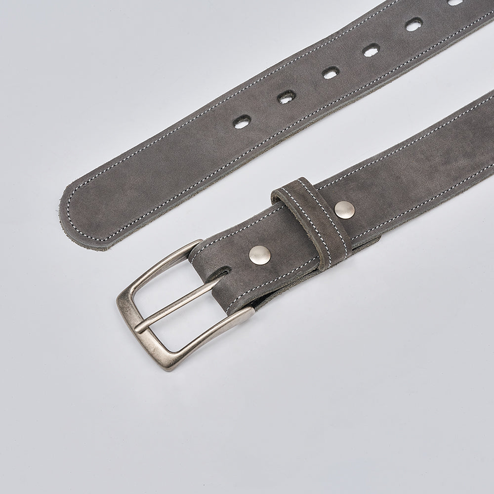 The Suede - 1.5" by Hanks Belts is a gray nubuck suede belt with a silver buckle, double rivets, white stitching, and multiple adjustment holes for the perfect fit, made in the USA. Shown against a plain light background.