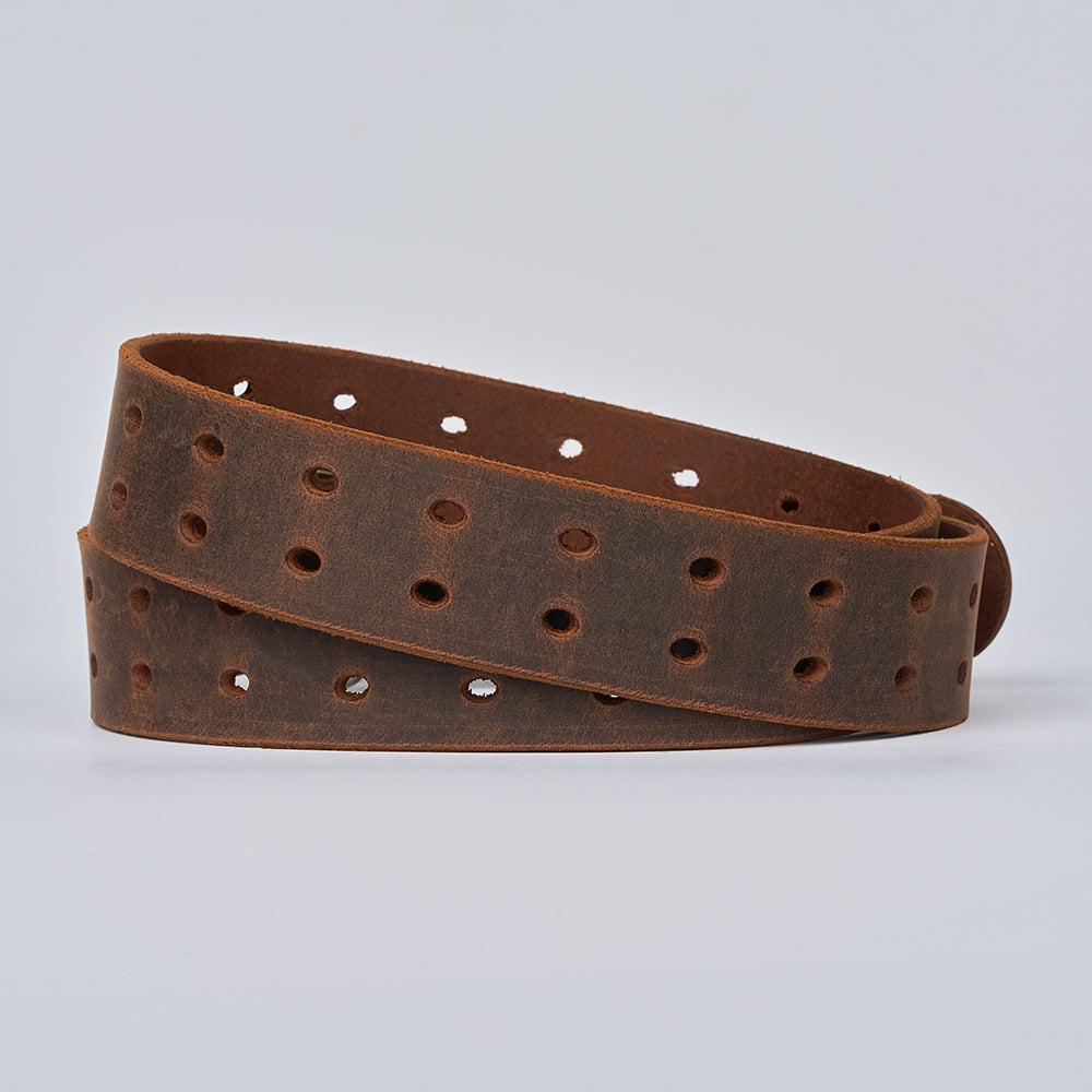 The Woodstock Double Prong Retro Style by Hanks Belts, made from full-grain leather and featuring rows of round holes, is coiled on a plain light background.