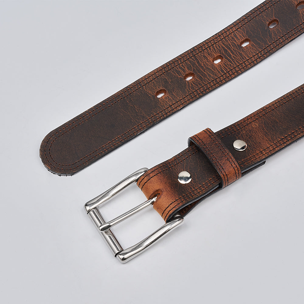 The Wyoming Bison by Hanks Belts is a lightweight casual brown belt made from bison leather, featuring a textured finish, silver rectangular buckle, metal rivets, and multiple adjustment holes.