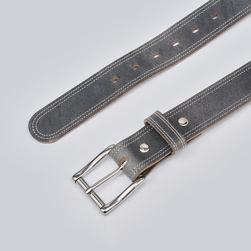 The Hanks Belts Wyoming Bison belt, shown in gray with white stitching and a silver buckle, features multiple adjustment holes. Lightweight and durable, it offers refined casual style on a simple light background.