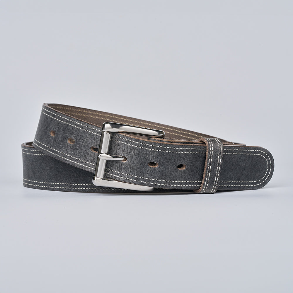 The Wyoming Bison by Hanks Belts is a black bison leather belt with white stitching and a silver buckle, shown coiled on a light gray background—a lightweight, casual classic.