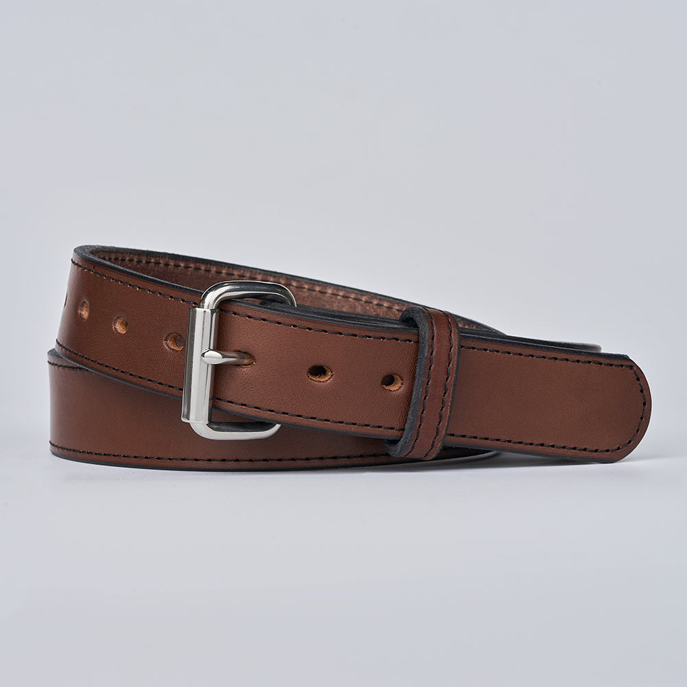 The Xtreme - 1.5" by Hanks Belts is a brown leather gun belt with a silver buckle, coiled on a plain light gray background. This heavy duty belt has stitched edges and multiple adjustment holes for a secure, comfortable fit.