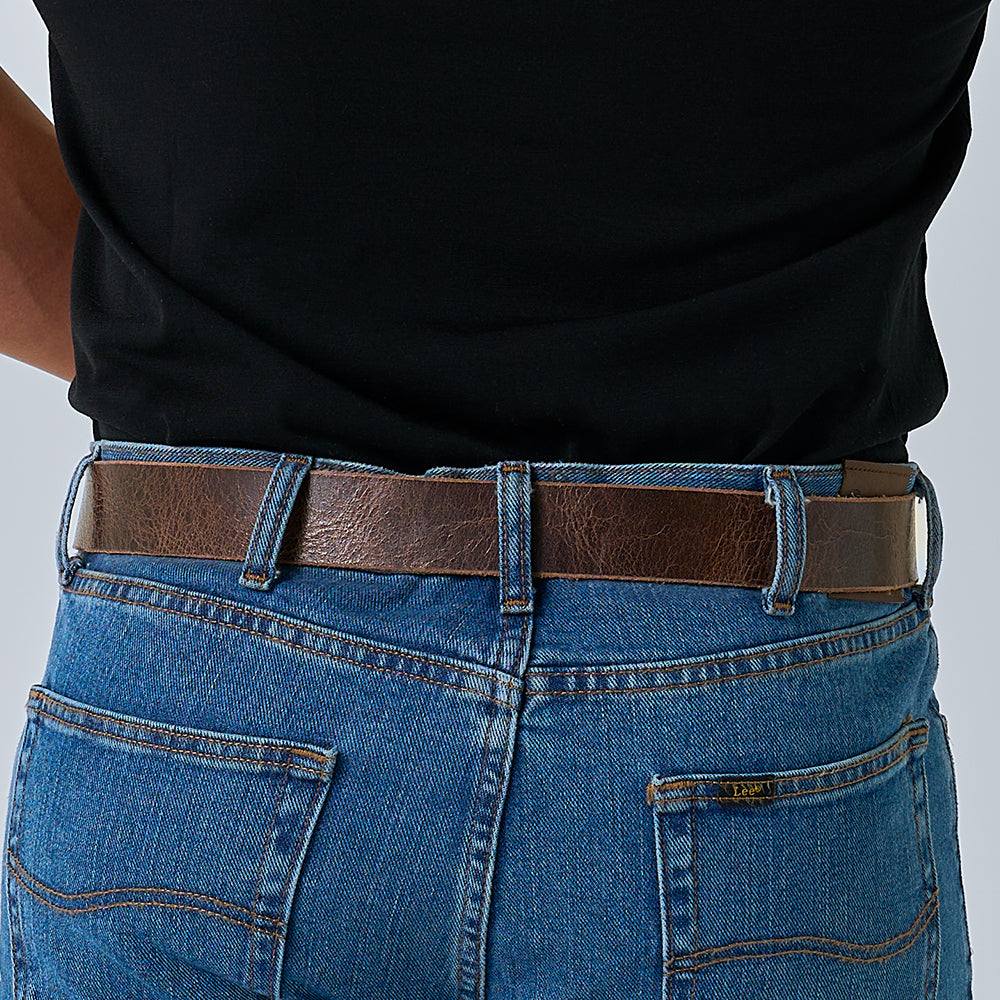 A person wearing a black shirt tucked into blue jeans, shown from the back waist down, featuring The Rustic Glazed full grain leather belt by Hanks Belts.