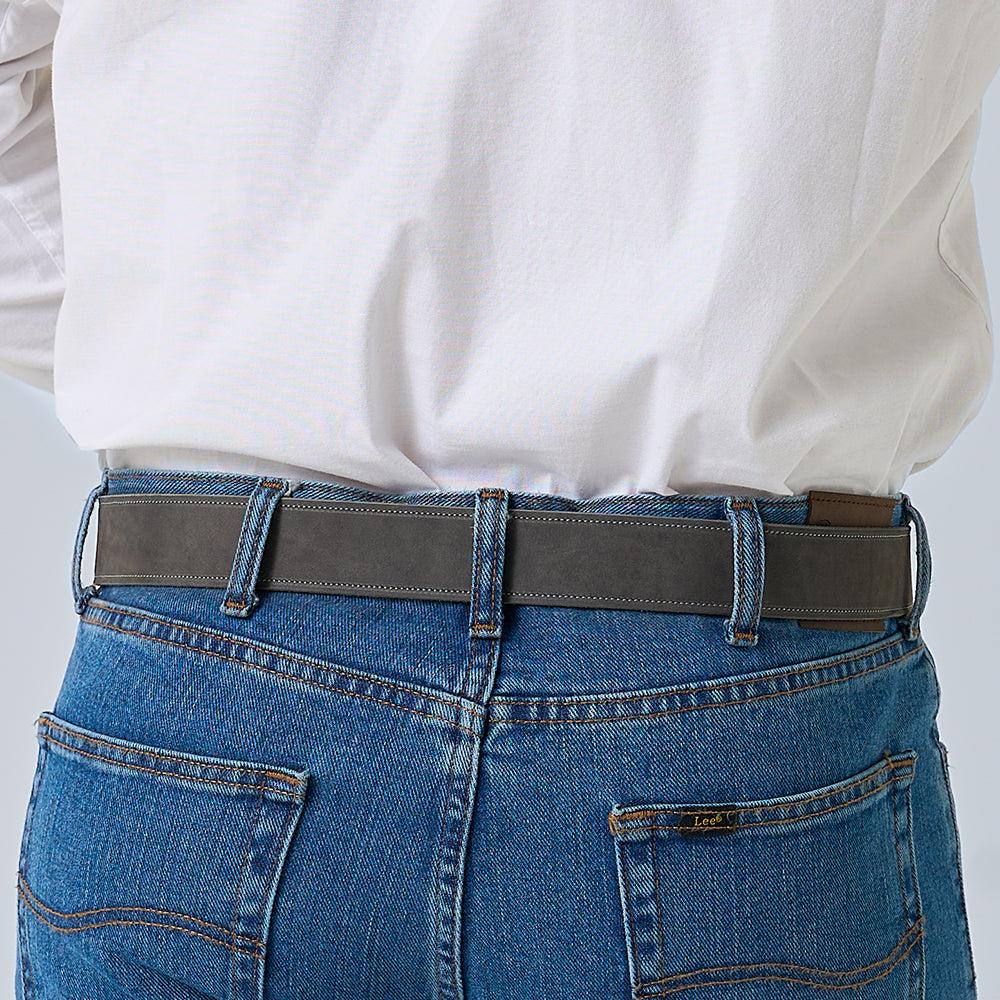 A person shown from the back wearing blue jeans, a white shirt, and Hanks Belts' The Suede - 1.5" dark gray nubuck leather belt.