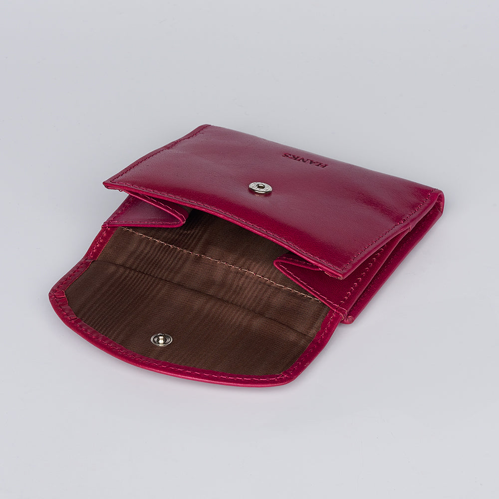 The Adelina Mini Bifold by Hanks Belts is a small, open pink leather wallet with a snap button closure and brown fabric-lined interior compartments, displayed on a plain white background.
