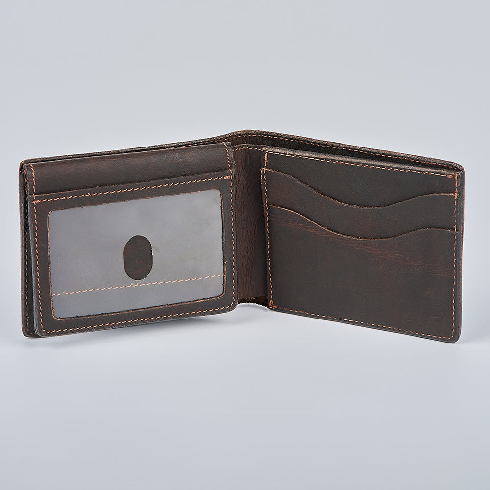 The Champlain Bison Bifold with ID Window by Hanks Belts is a brown leather wallet, shown open on a light gray background, featuring visible card slots and a transparent ID section.