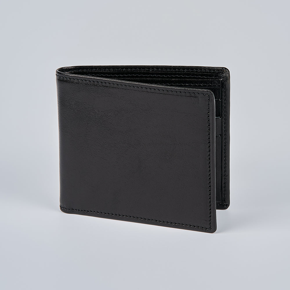 The Hanks Belts Como Italian Bifold wallet in black stands upright on a plain light gray background.