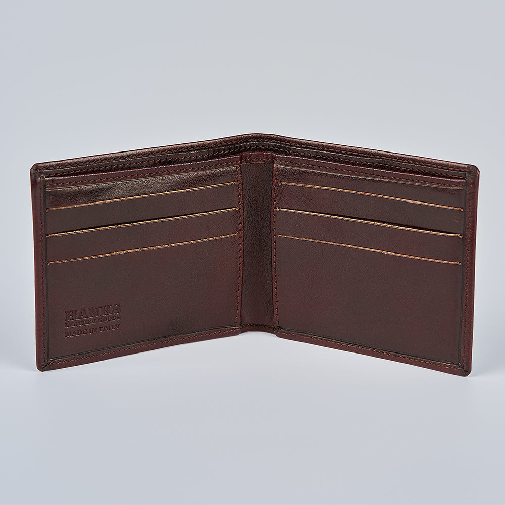 The Como Italian Bifold by Hanks Belts is shown open, displaying multiple card slots, fine stitching, and gold-stamped “HANKS BELTS” and “MADE IN USA” details inside the left pocket.