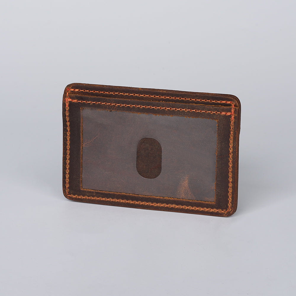 The Hamlin Card Holder with ID Window by Hanks Belts is a brown Steerhide leather wallet featuring visible stitching and a transparent ID window, made in the USA and shown on a plain light gray background.