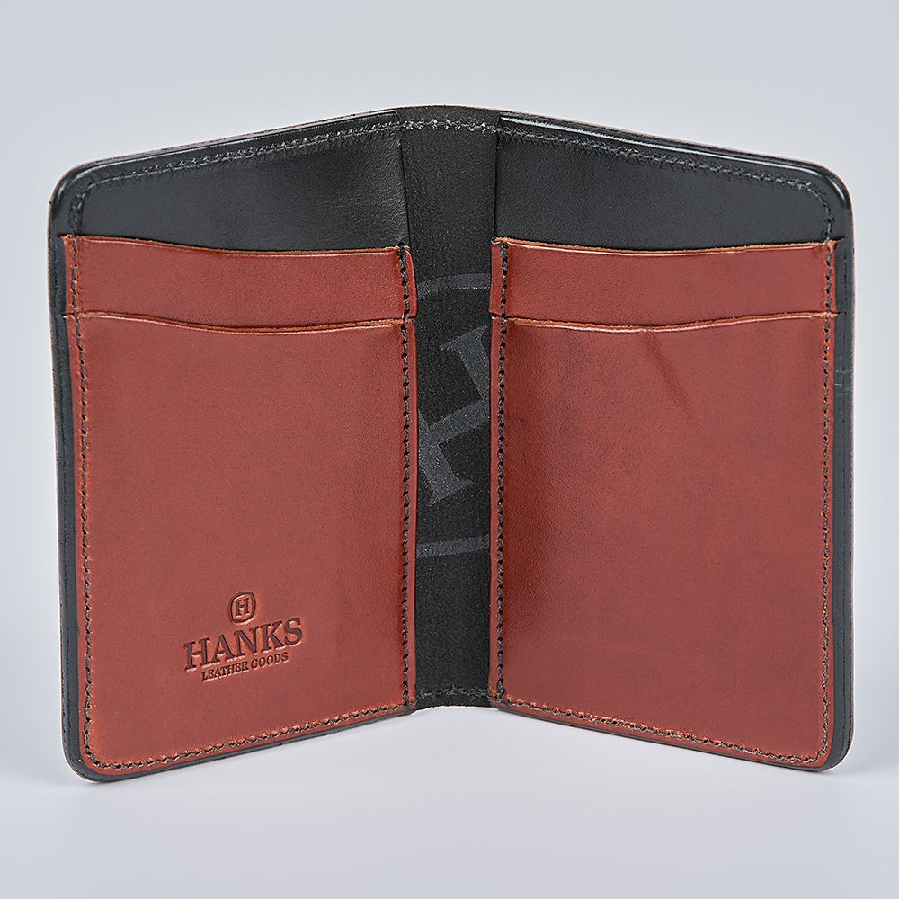 Open brown and black Superior Front Pocket Bifold wallet by Hanks Belts showing four card slots and the "HANKS BELTS" logo embossed on the bottom left pocket, set against a plain background. This handcrafted wallet is built to last.