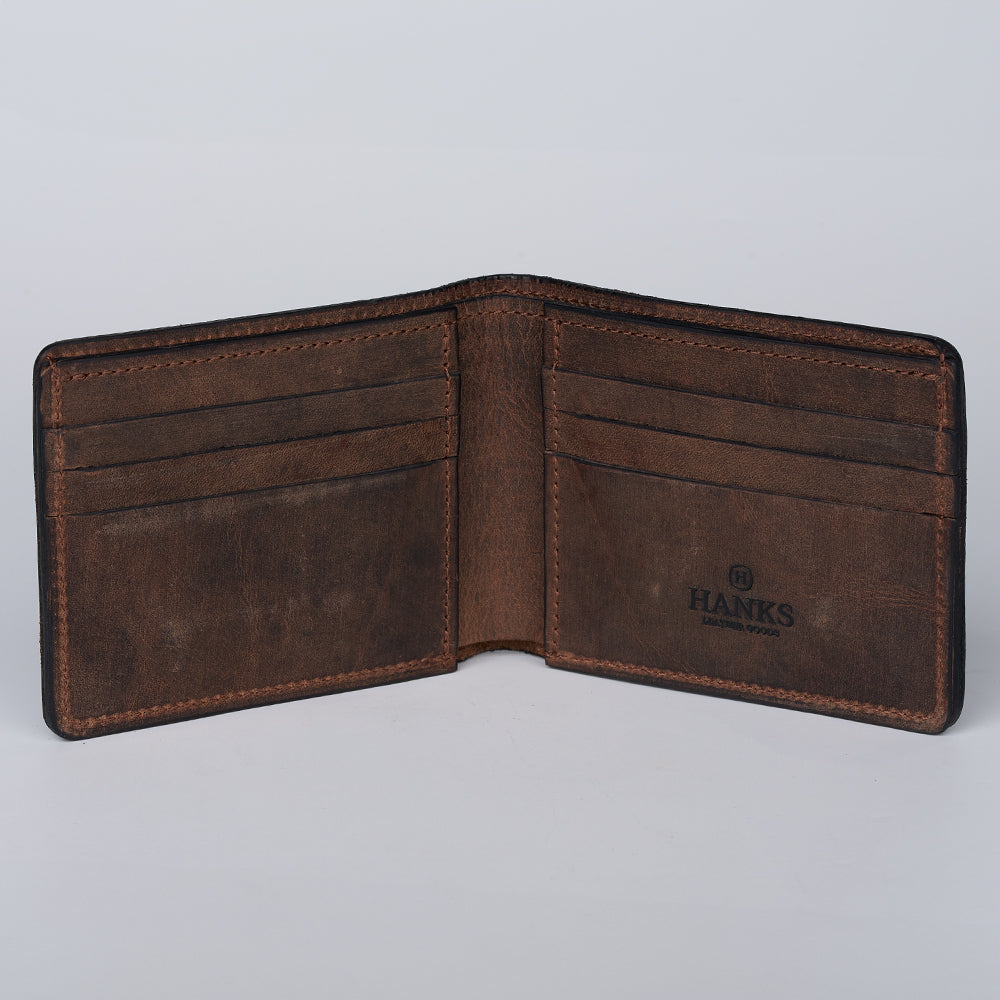 The Tahoe Bifold by Hanks Belts is an open brown steerhide leather slim bifold wallet with multiple card slots and the "HAN KS" logo on the right inner panel—an elegant American-made essential.