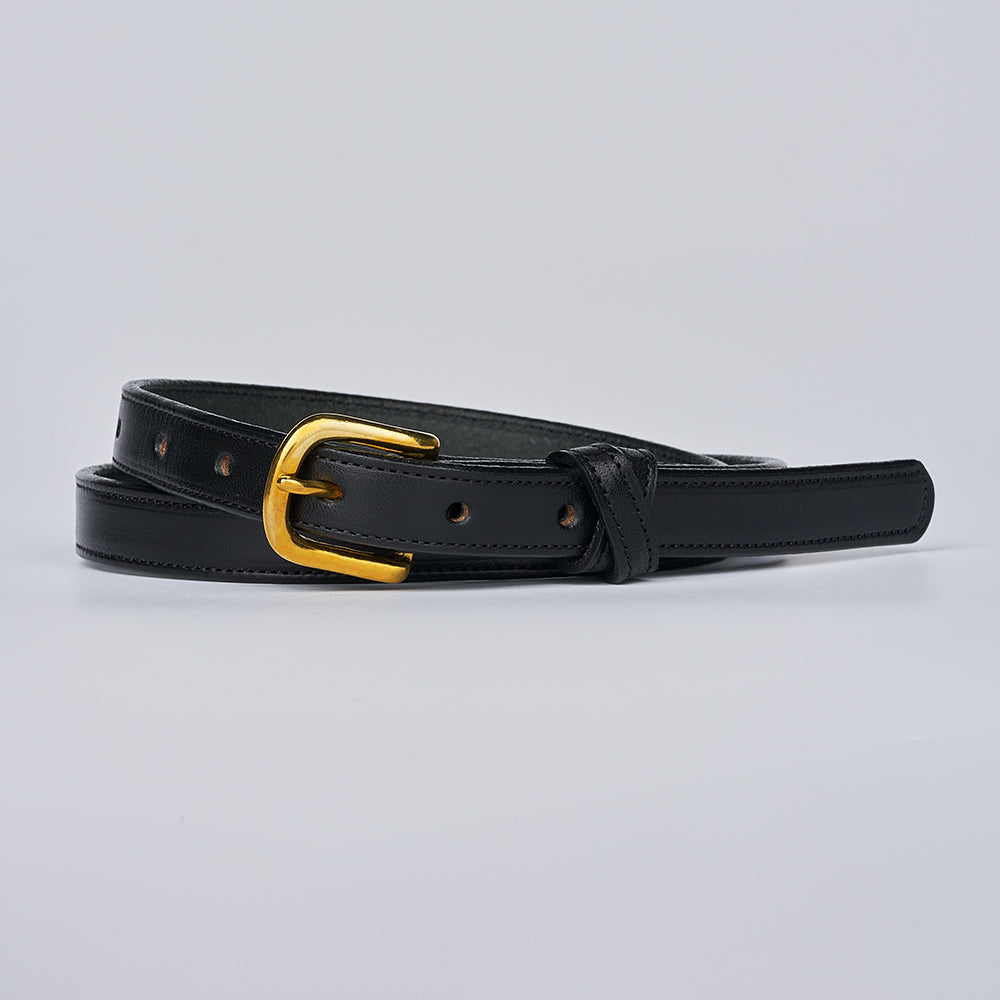 The Dixie by Hanks Belts is a women’s English Bridle leather belt, made in the USA, featuring a shiny gold buckle and shown coiled on a light gray background.