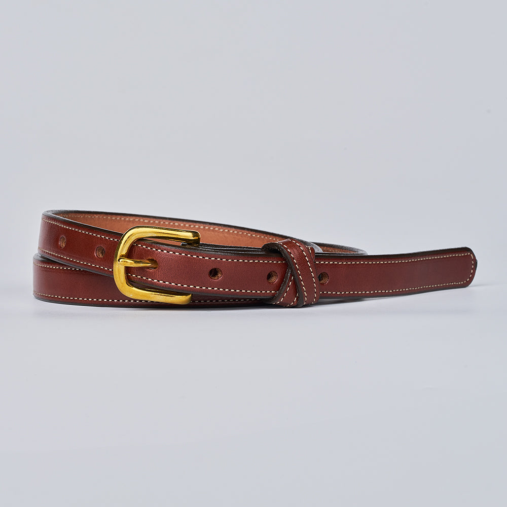 The Dixie by Hanks Belts is a stylish brown women’s belt with white stitching and a gold buckle, crafted from premium English Bridle leather and shown coiled on a plain light gray background.
